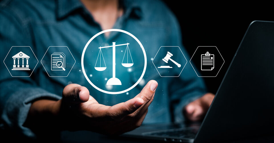 Digitalized symbols representing law and justice in circles with a man's hand holding the scales