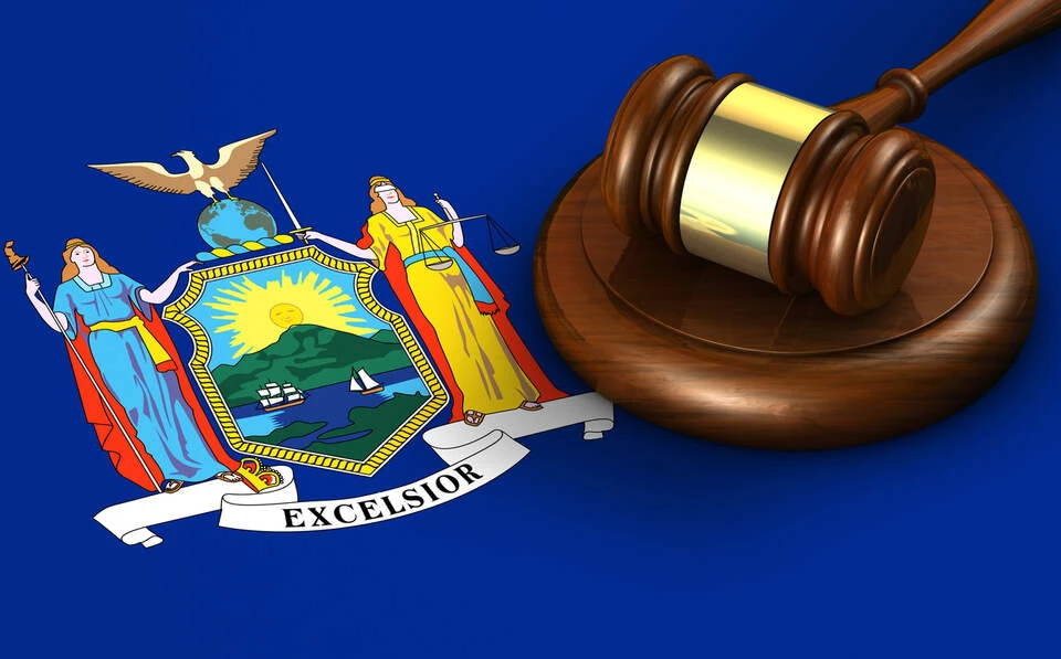 A gavel on the New Yorker flag on background.