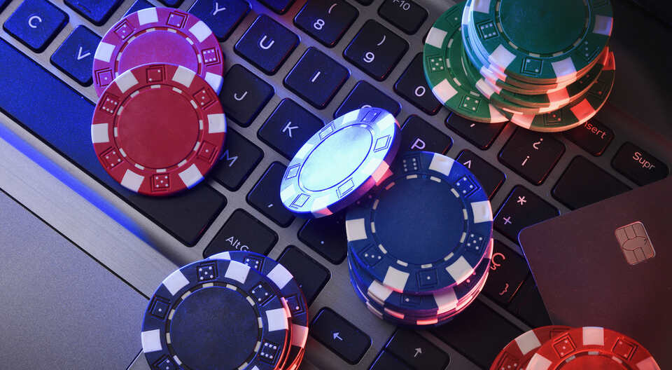 Chips and a bank card on laptop keyboard