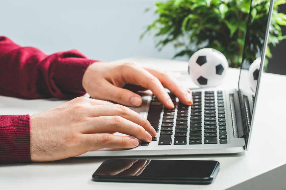 Close up cropped shot of male hands typing on keyboard
