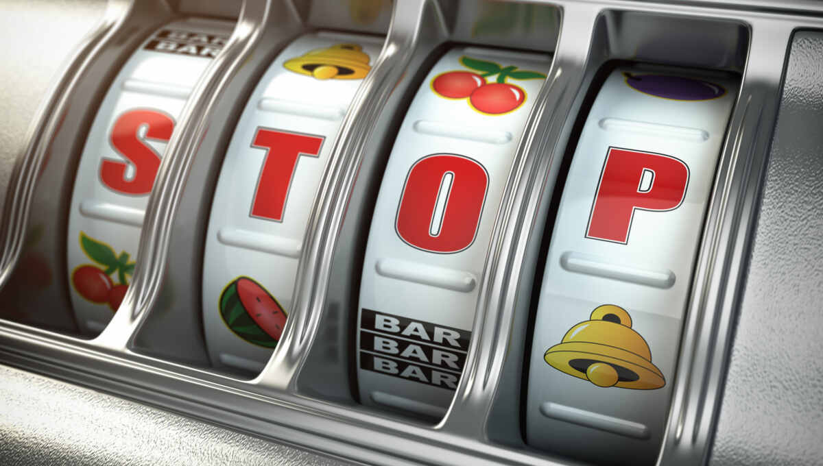 Slot Machine with the word STOP being spelled out as symbols