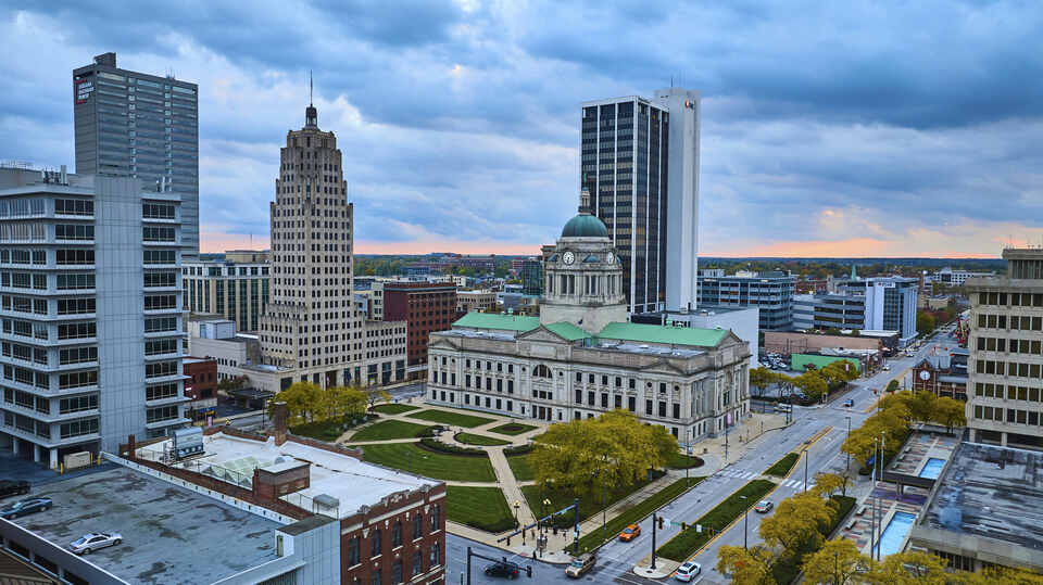 Golden hour skyline over Fort Wayne, Indiana showcasing a historic courthouse amidst modern architecture